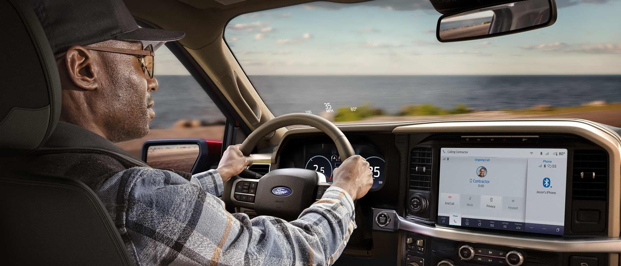 Man driving a 2025 Ford F-150® King Ranch® showing the center stack display screen
