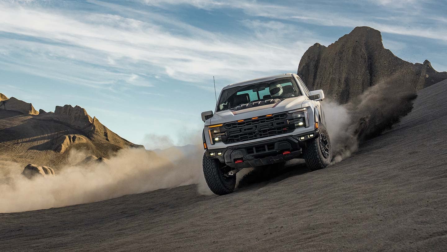 2024 F-150® Raptor R™ being driven in the desert kicking clouds of sand