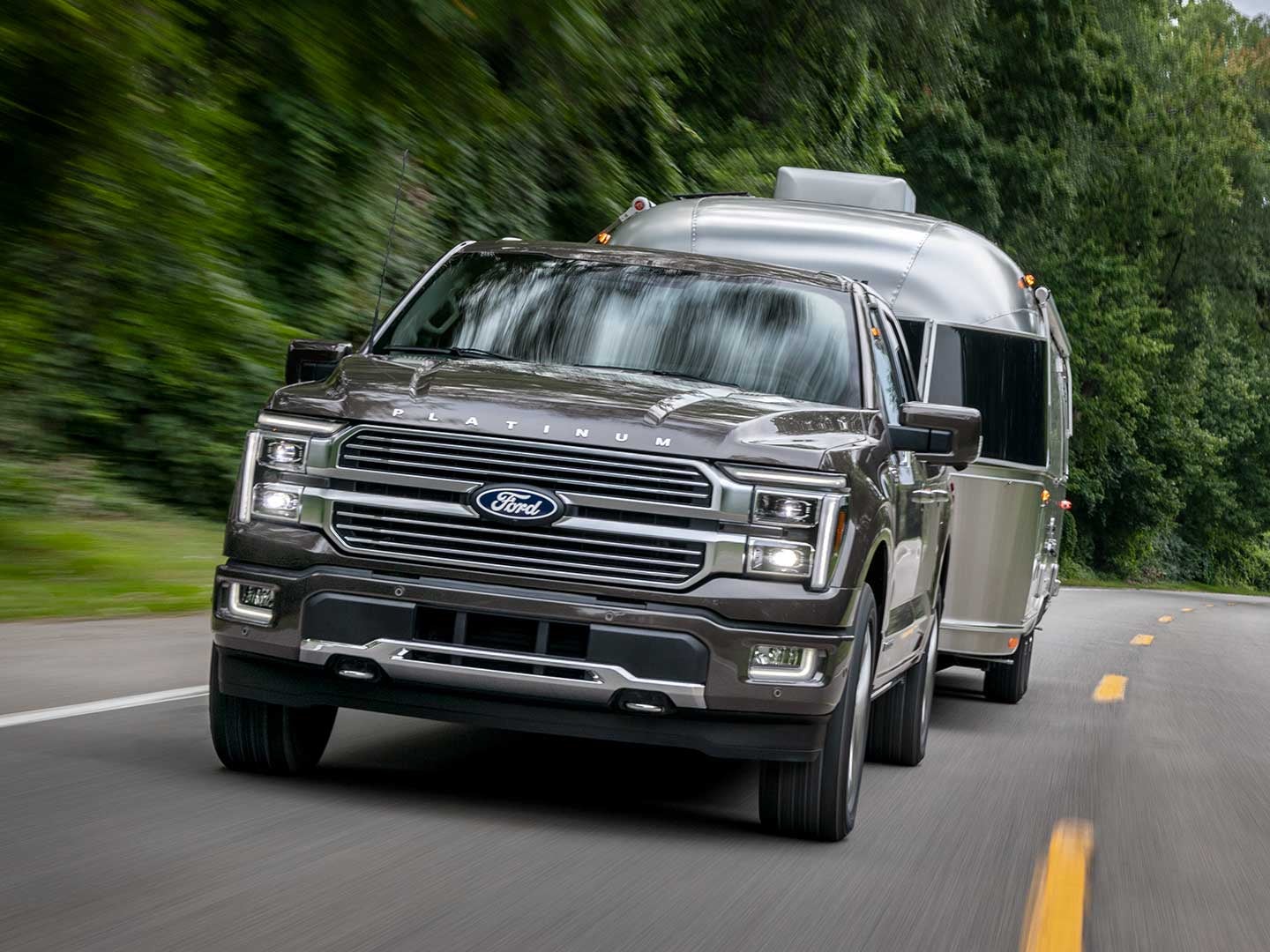 2025 Ford F-150® Platinum® pickup pulling a camper
